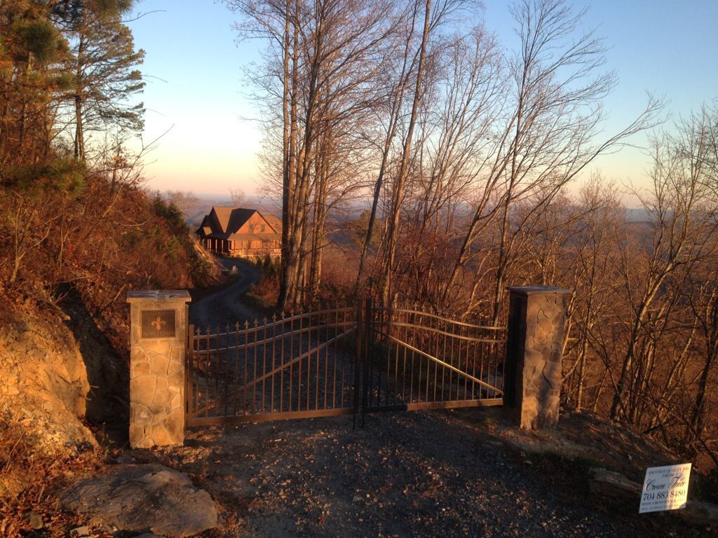 A gate leading to a house in the woods