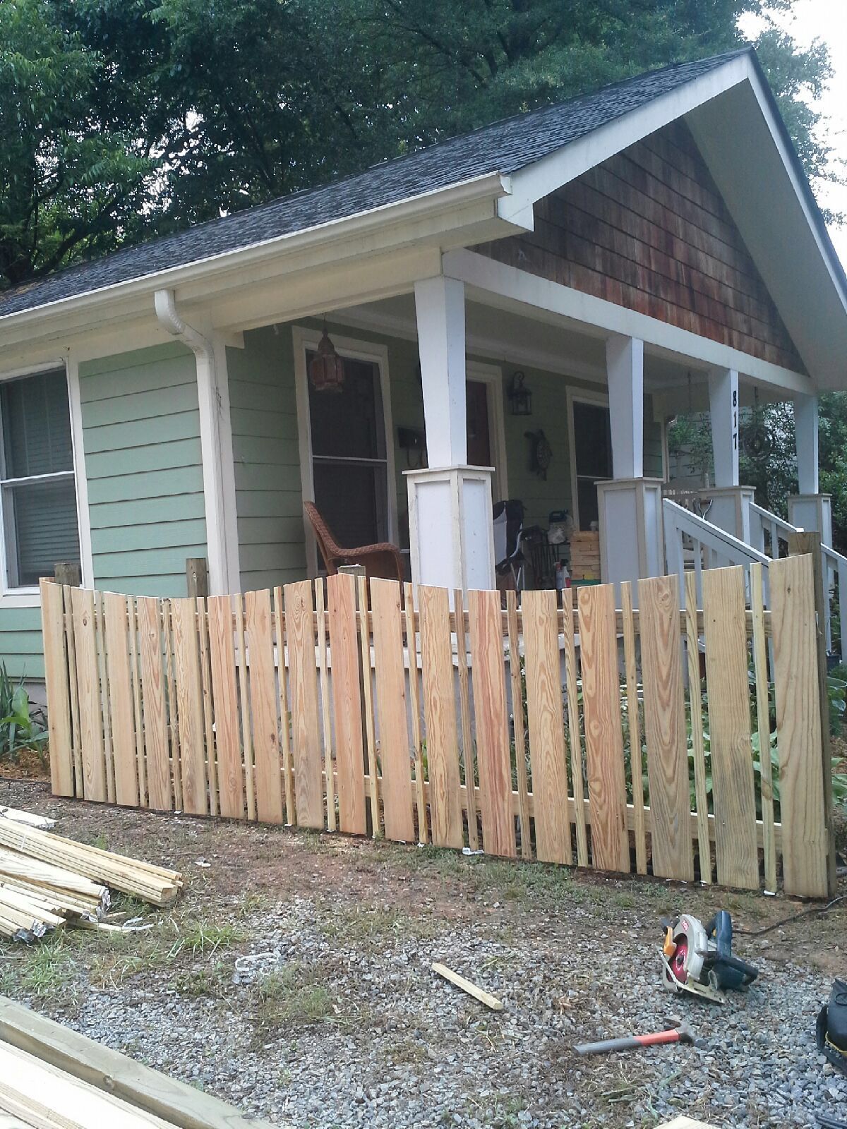 A house with a wooden fence in front of it