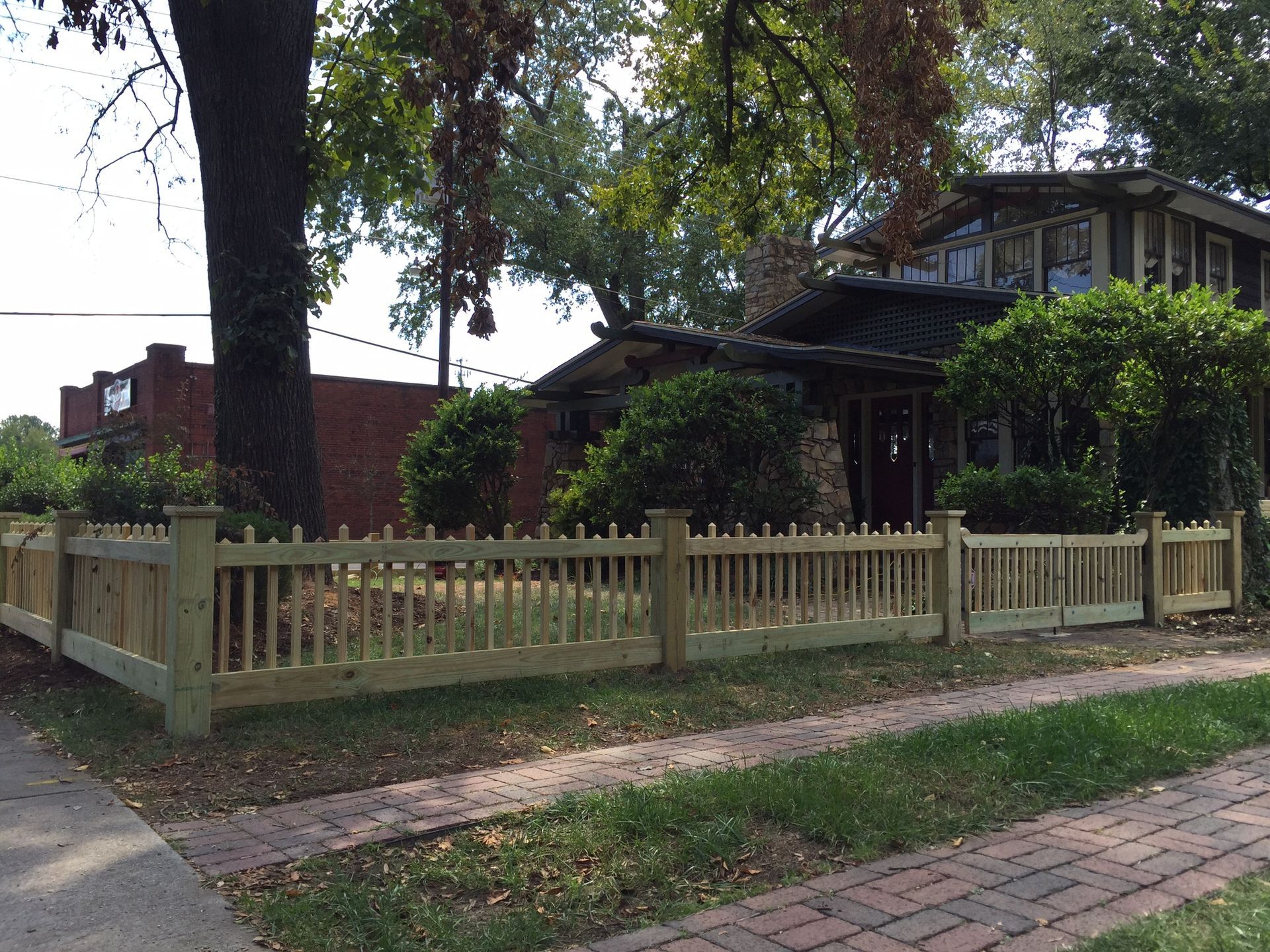 A house with a wooden fence in front of it