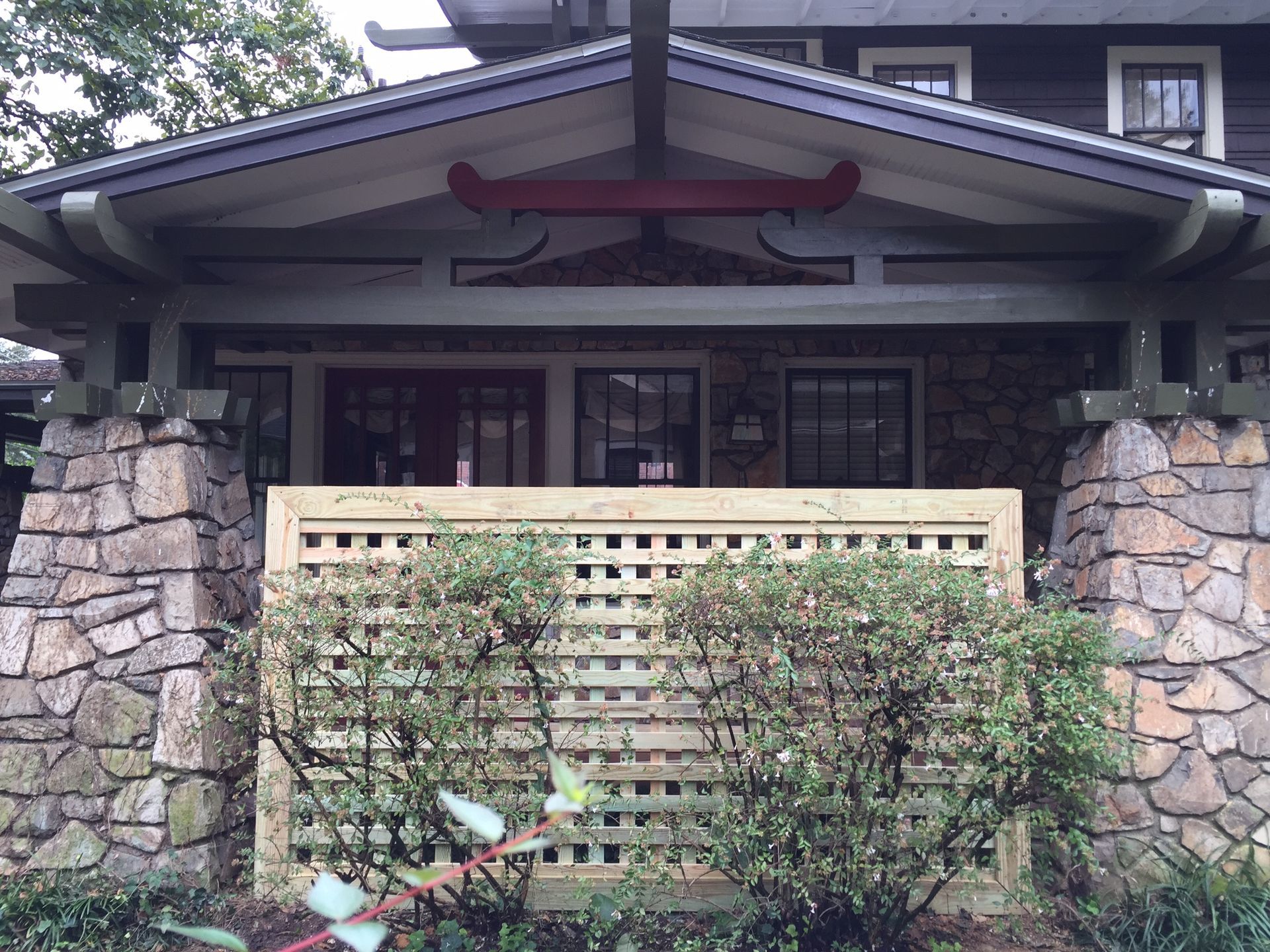 A house with a wooden fence in front of it