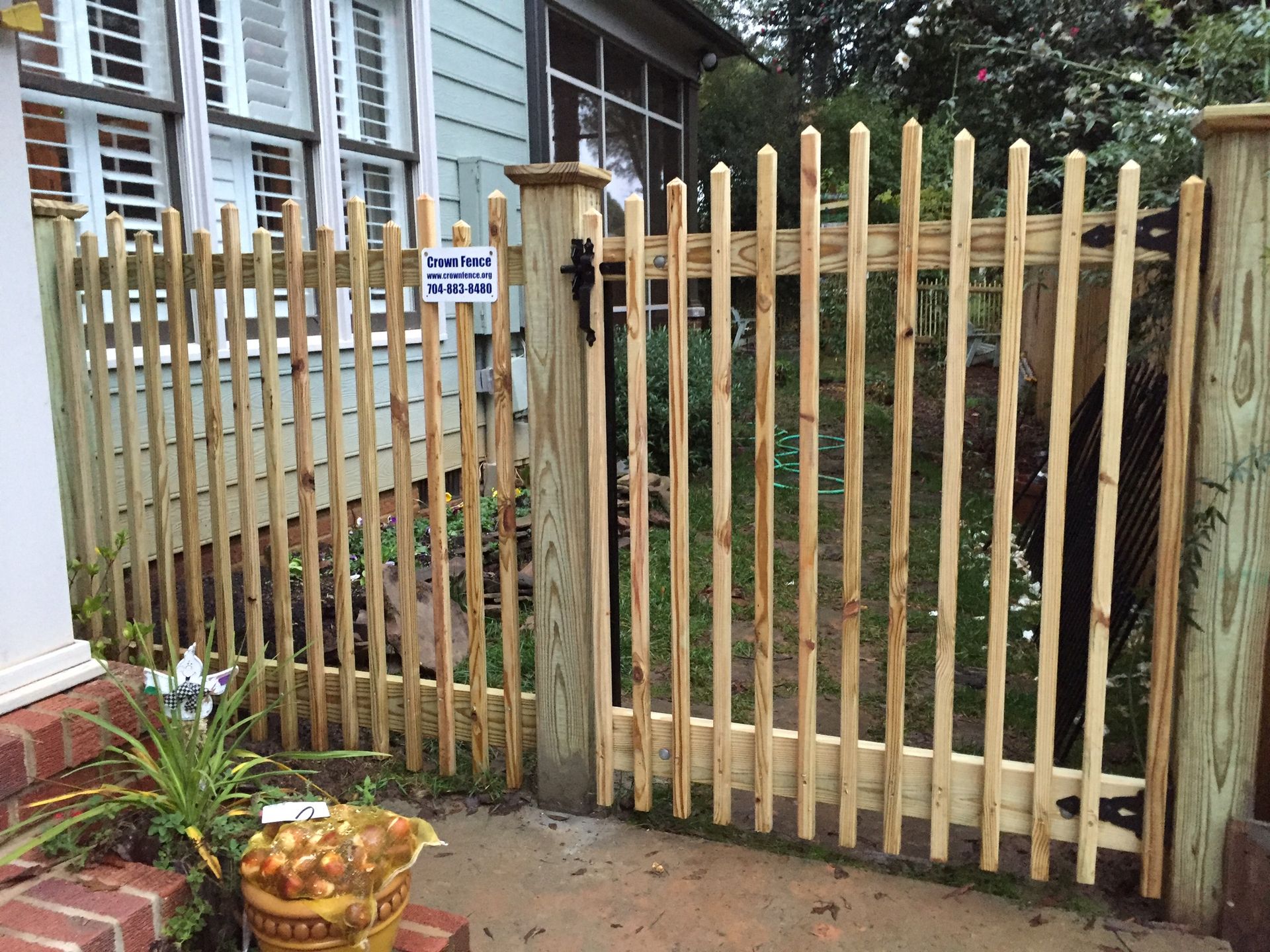 A wooden fence with a sign that says