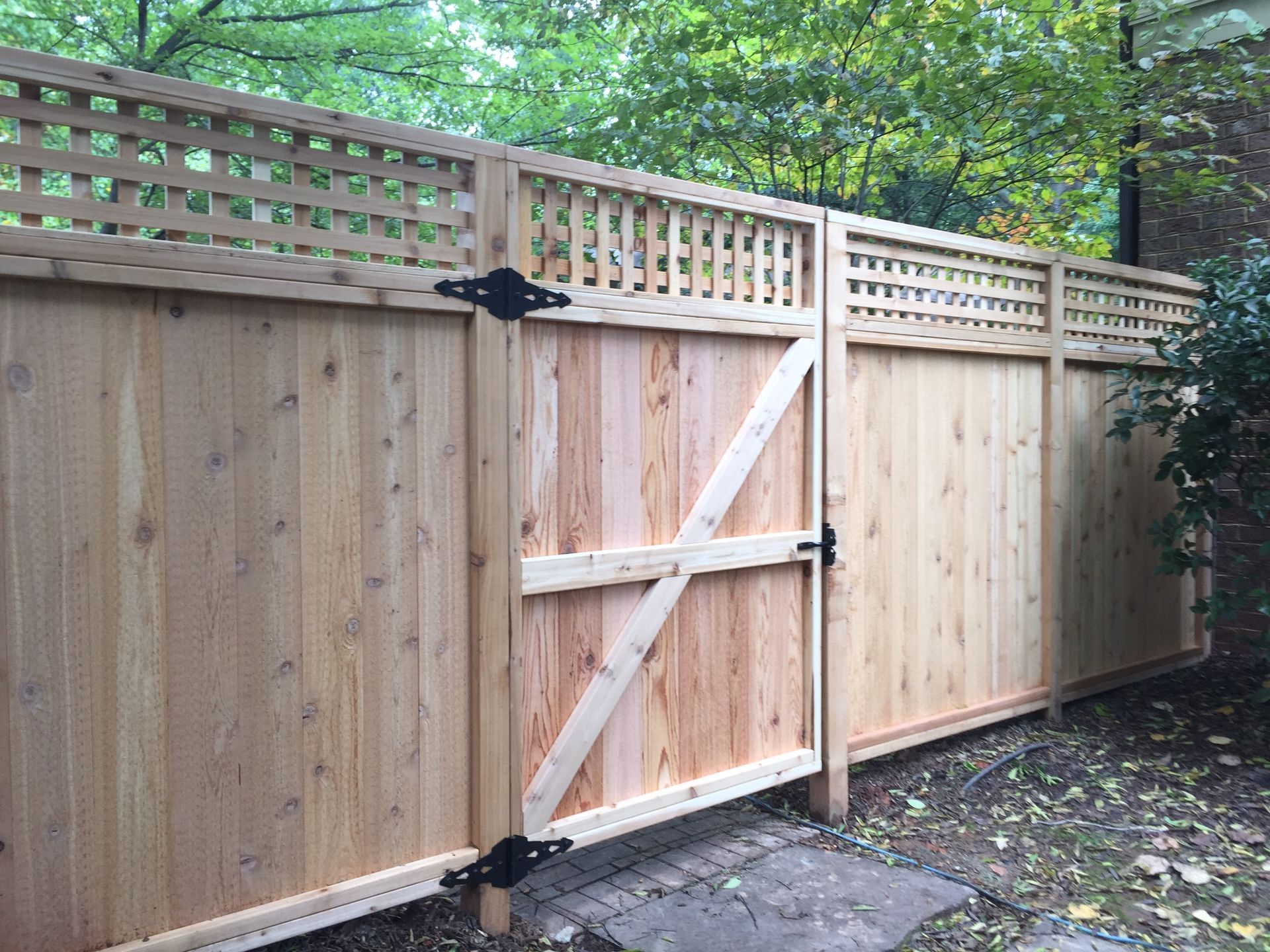 A wooden fence with a gate attached to it.
