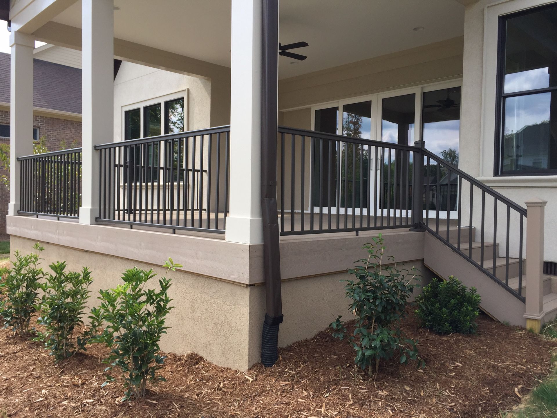 A porch with a railing and stairs leading up to it
