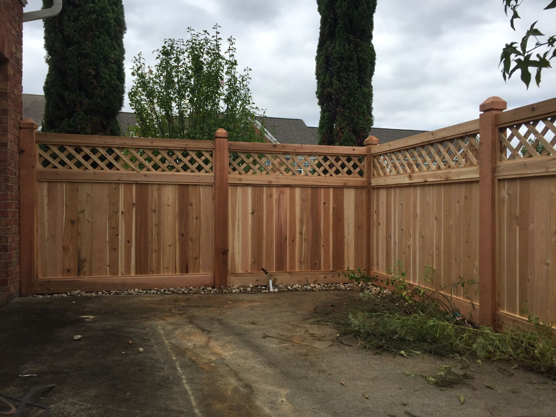A wooden fence with trees in the background