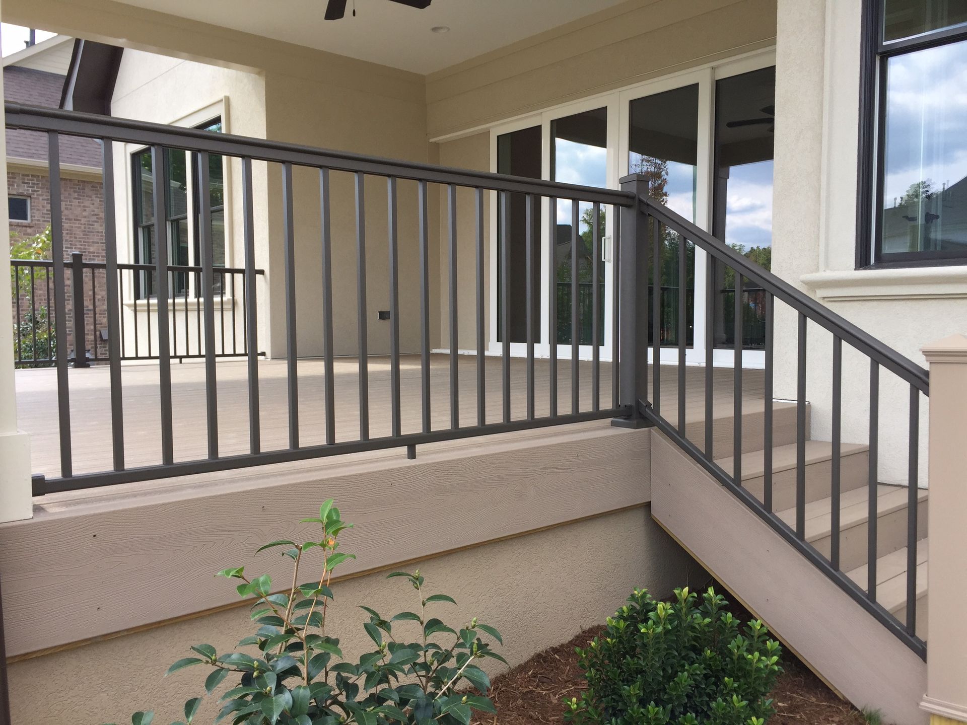 A balcony with a metal railing and stairs leading up to it.