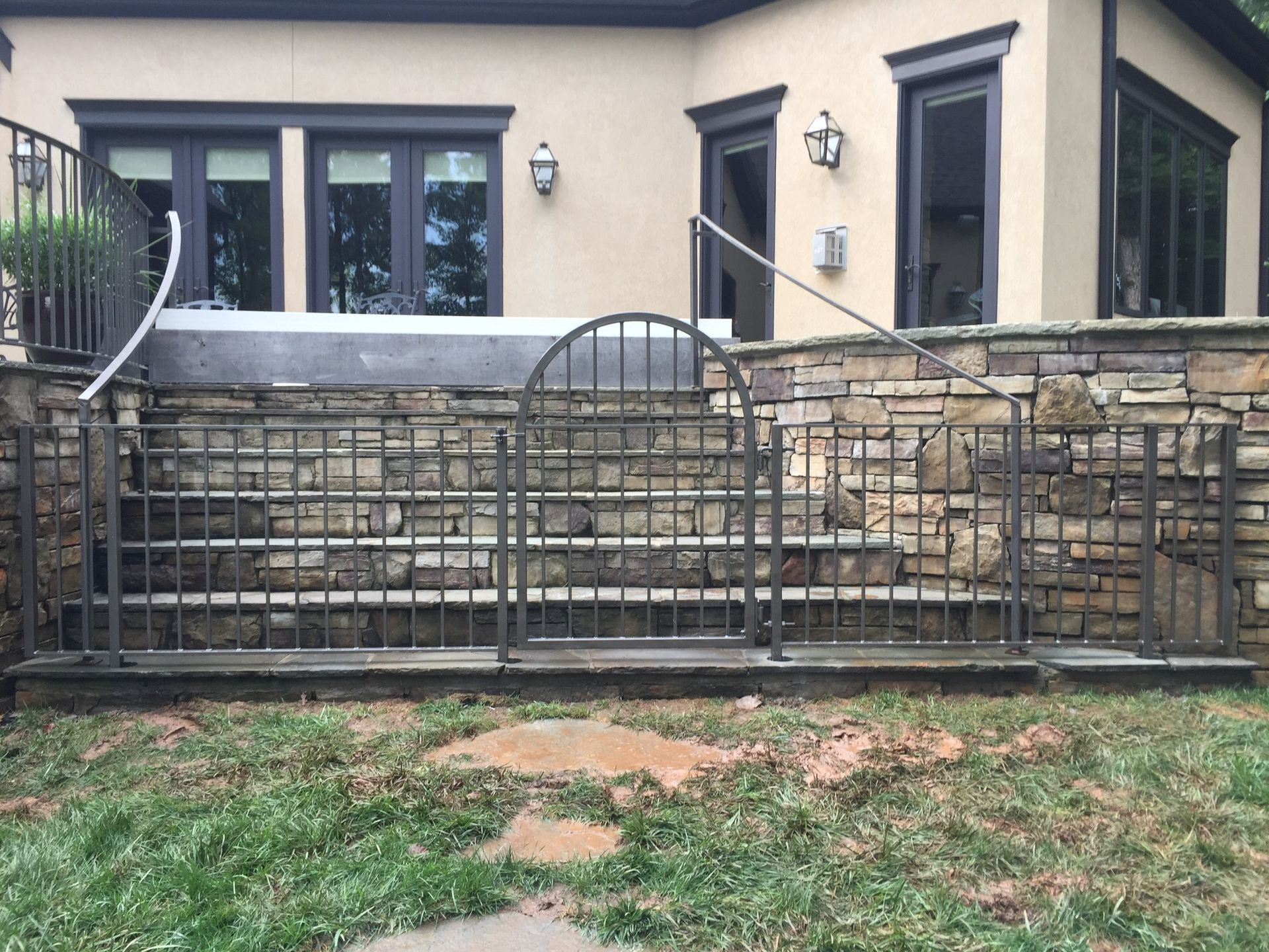 A house with stairs and a gate in front of it