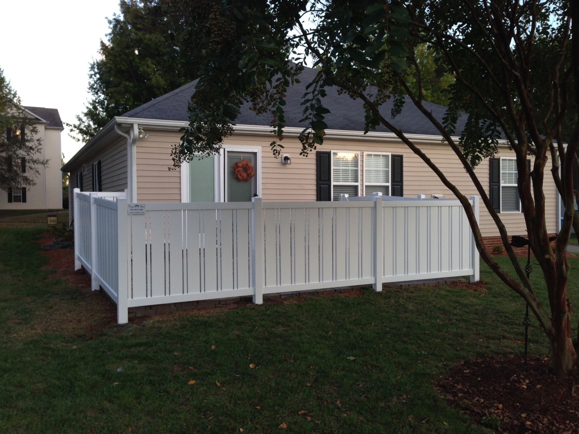 A house with a white fence in front of it
