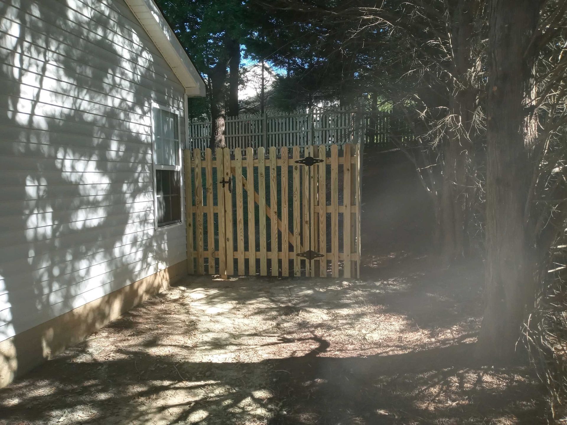 A white house with a wooden fence in front of it