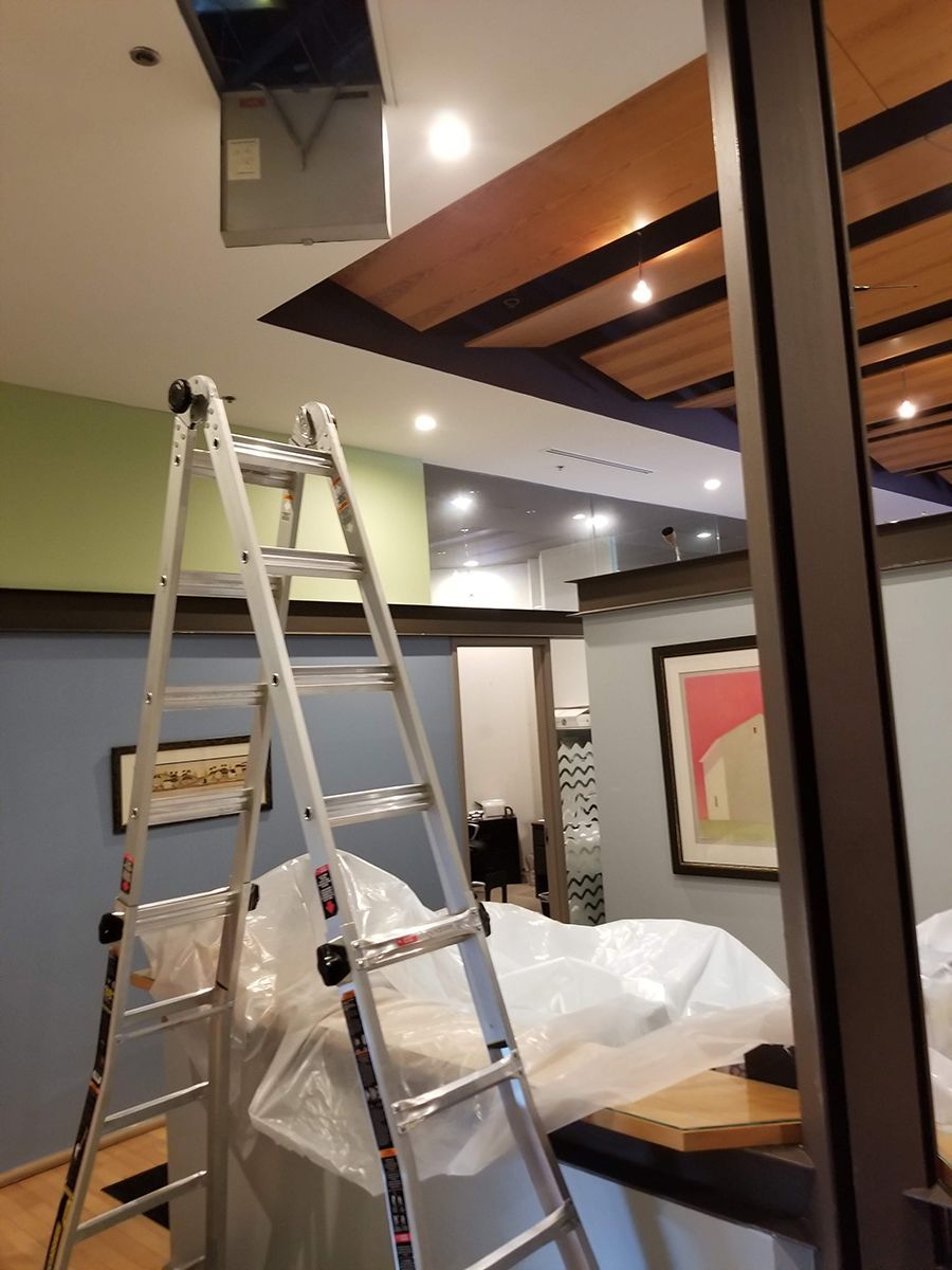A ladder is sitting in the middle of a room.