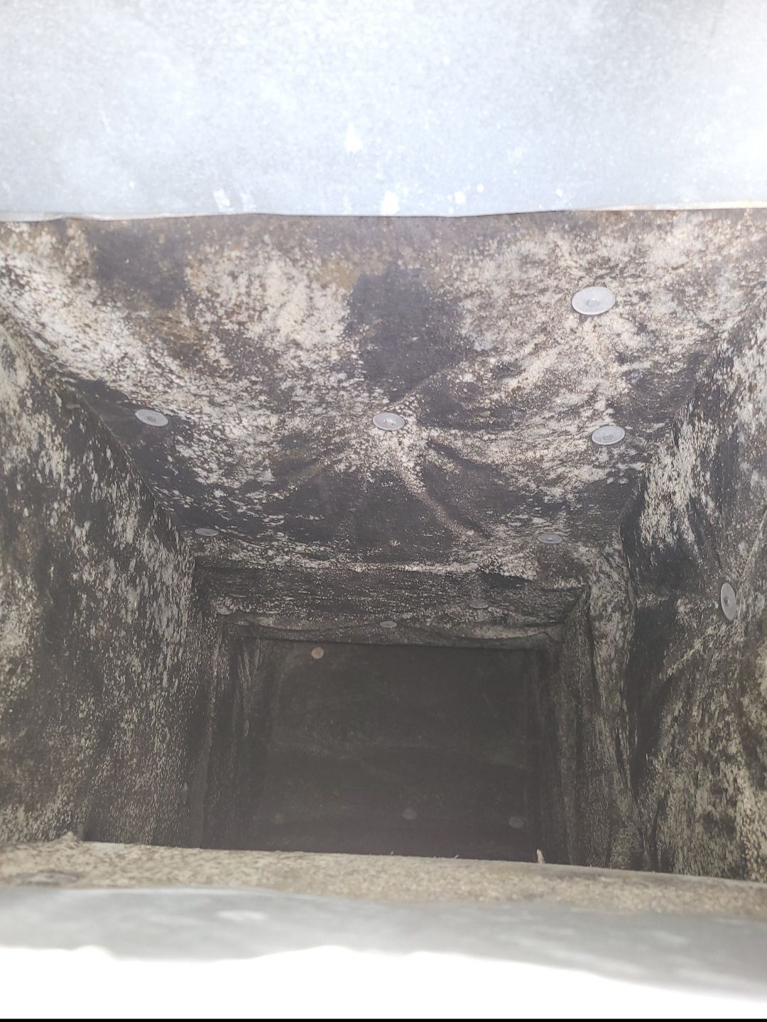 A close up of a hole in a wall that looks like a cave.