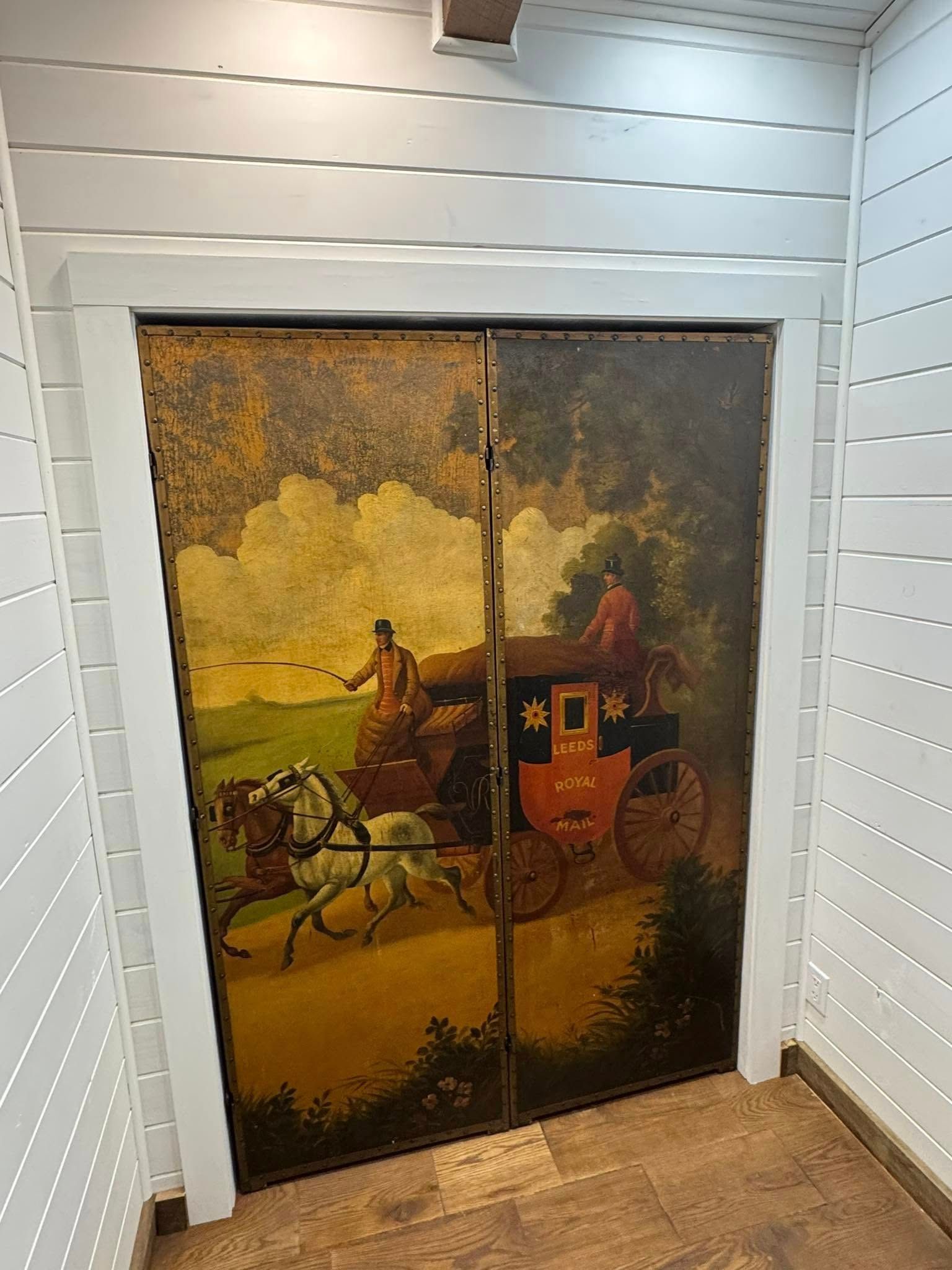 Two-door cabinet painted with a horse-drawn carriage scene.
