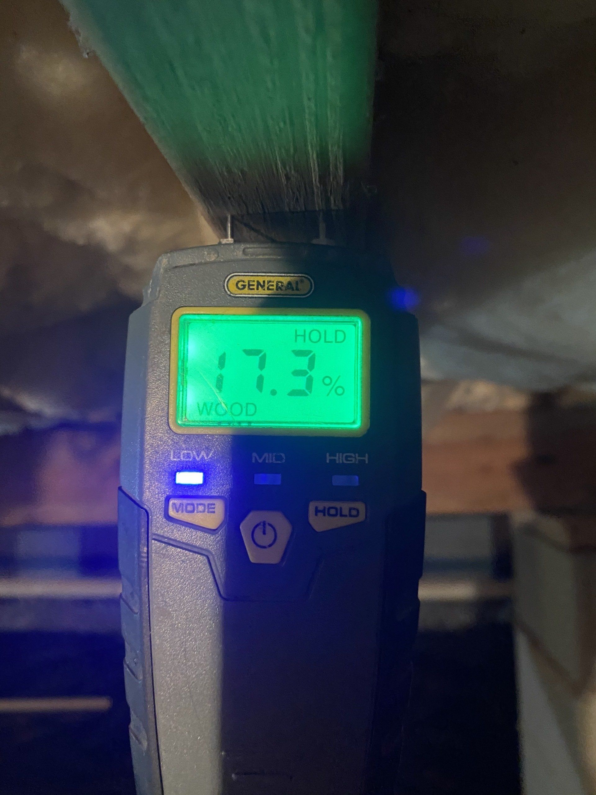 A digital thermometer is being used to measure the humidity of a room.