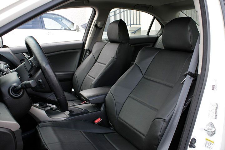 A white car with black seats and a steering wheel