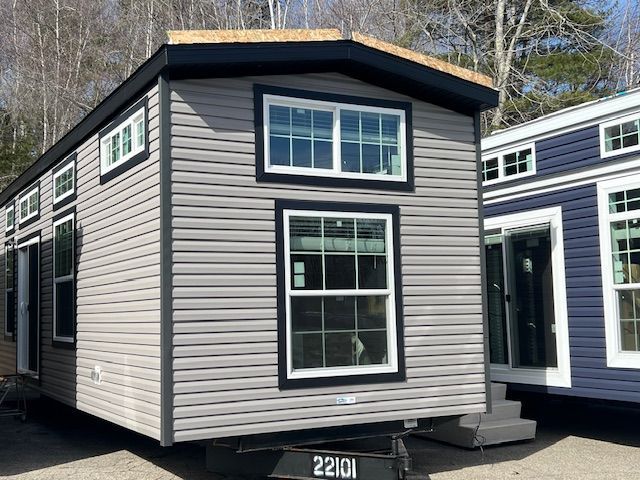 A tiny house is sitting on top of a trailer.
