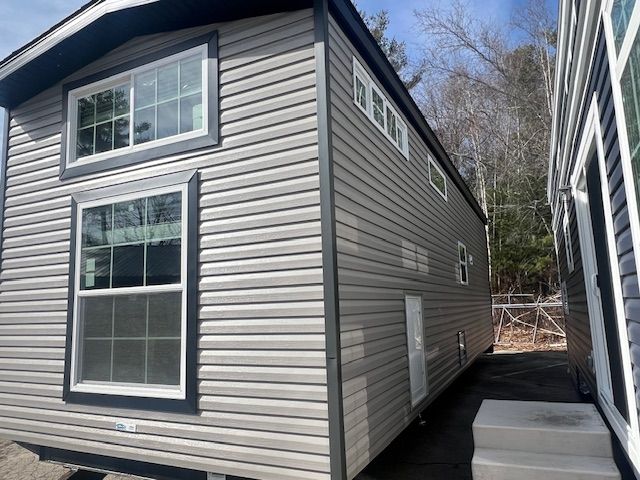 A mobile home with a lot of windows and stairs