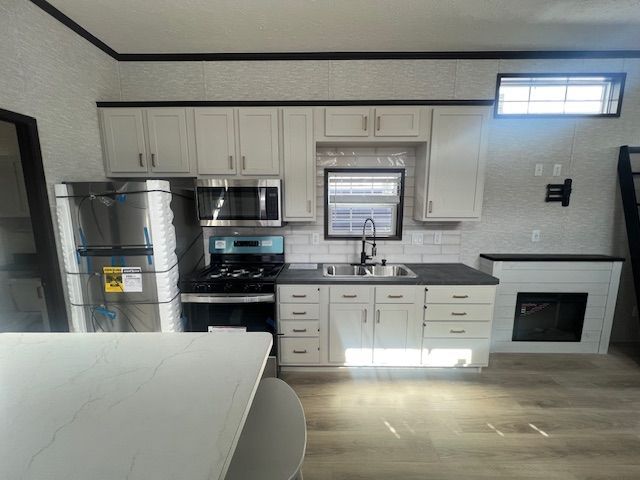A kitchen with stainless steel appliances and white cabinets