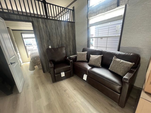 A living room with a couch , chair and bunk bed.