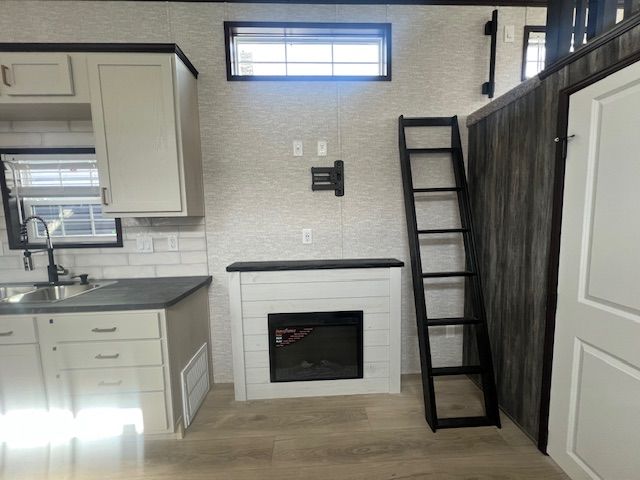 A kitchen with a fireplace and a ladder