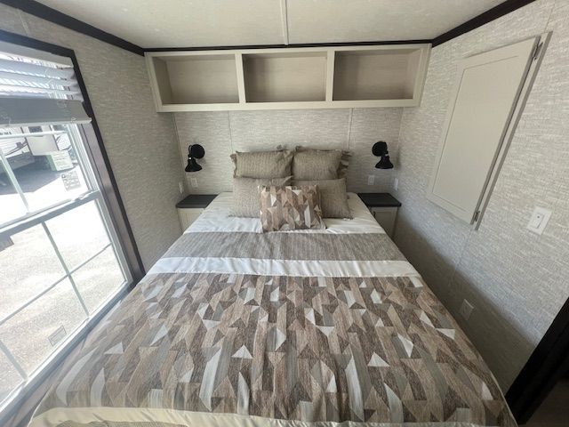 A small bedroom with a bed and a window