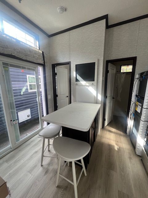 A kitchen with a table and stools in it
