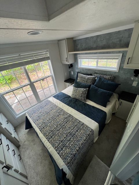 A bedroom with a large bed and a window.