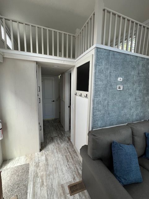 A living room with a couch and a balcony.