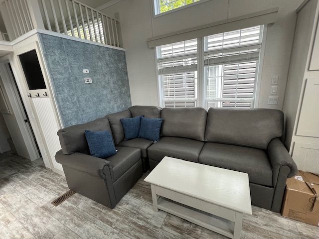A living room with a couch , chair , and coffee table.