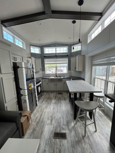 A kitchen with a table and stools in it
