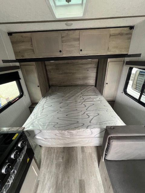 A mattress is sitting on top of a bed in a trailer.