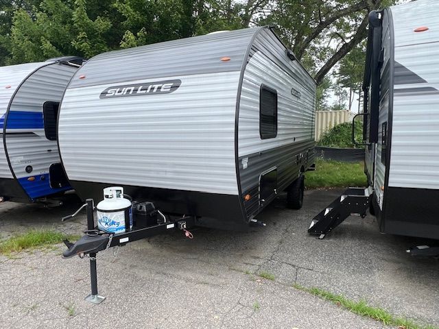 Two rvs are parked next to each other in a parking lot.