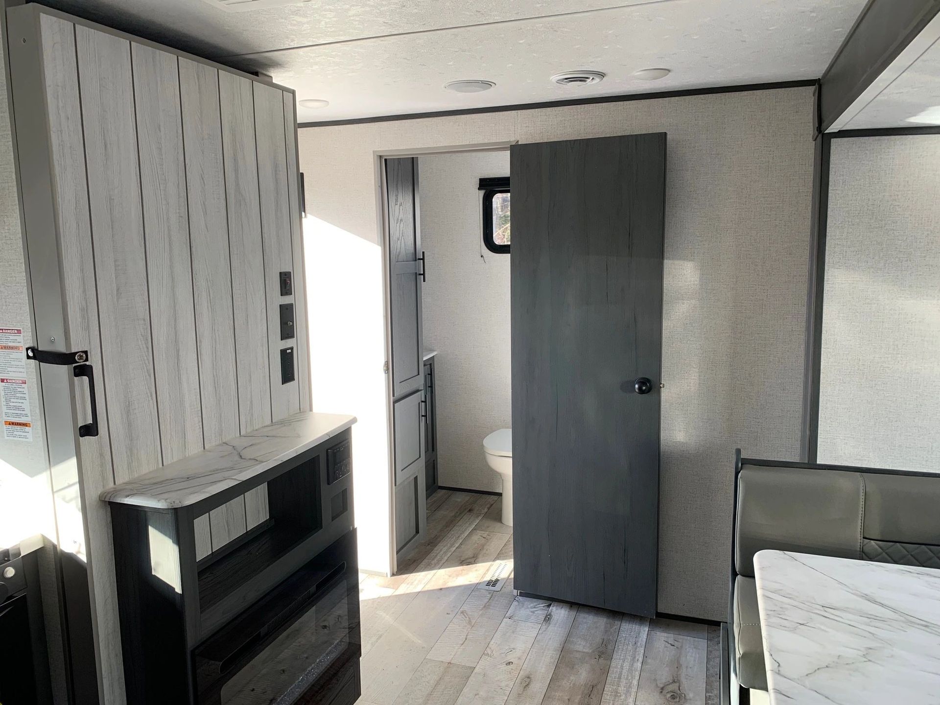 A room with a gray door and a white wall.