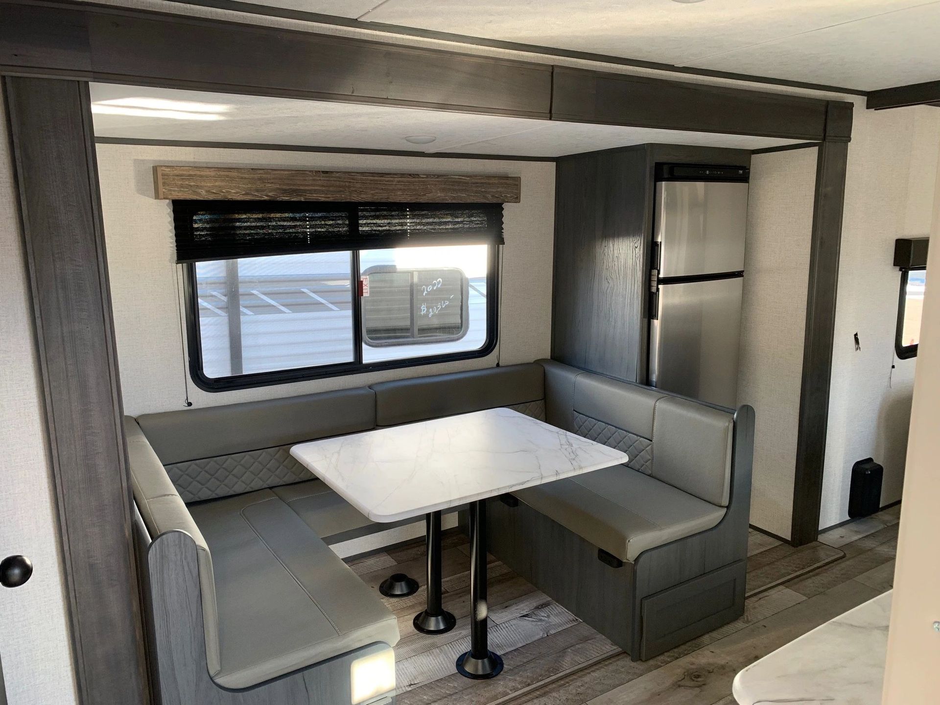A rv with a table and benches in it.