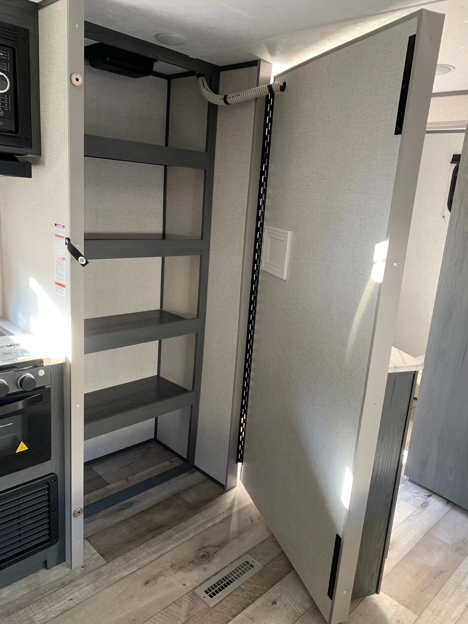 A closet with shelves and a door in a rv.