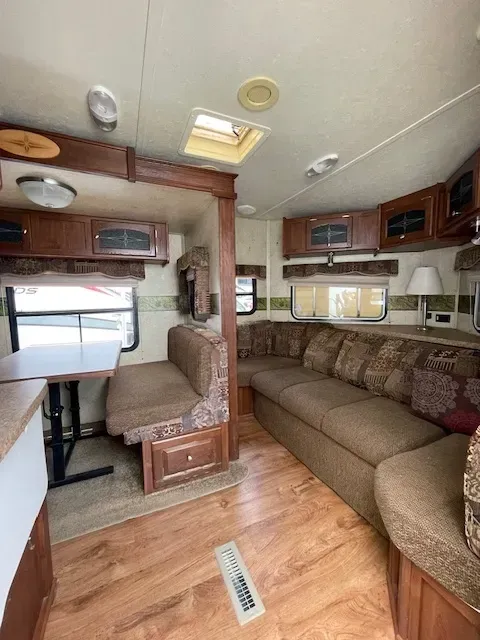 A rv with a couch and a table in it