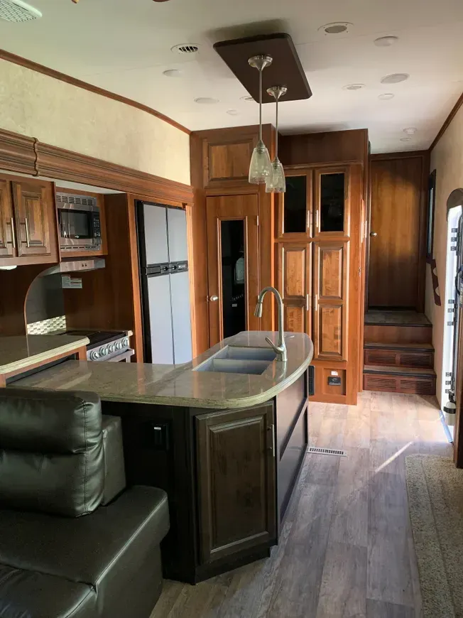 A kitchen with a large island and a couch