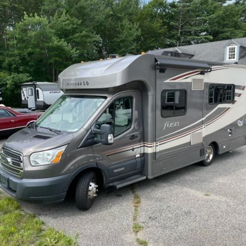A gray rv with the word fleet on the side