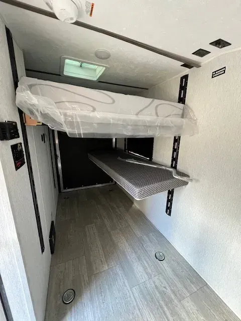 There is a bunk bed in the back of a trailer.