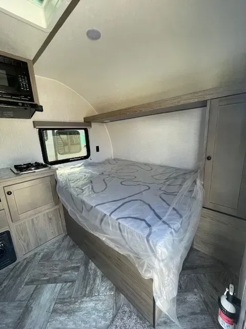 A rv with a bed and a mattress in it.