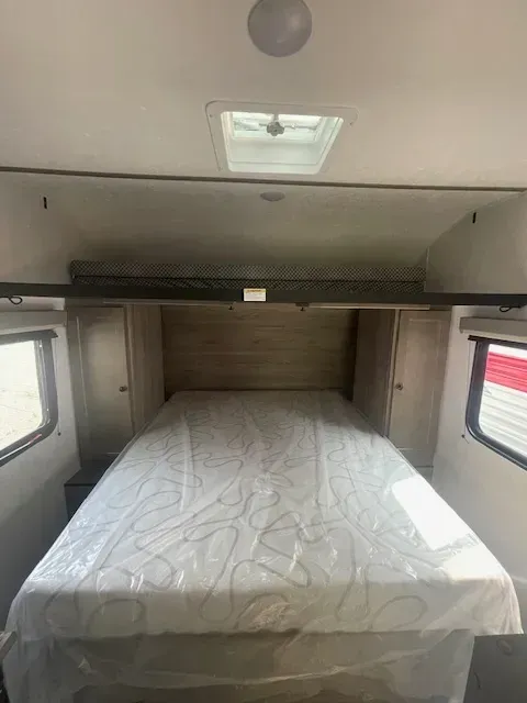 A rv with a bed and a mattress in it.