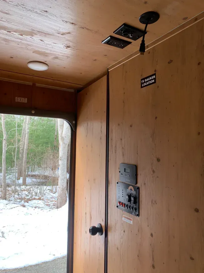 A wooden door with a sign on it that says