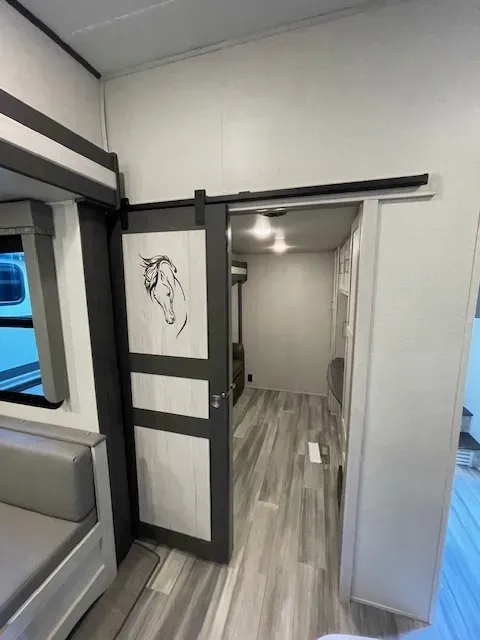 A sliding barn door with a picture of a horse on it