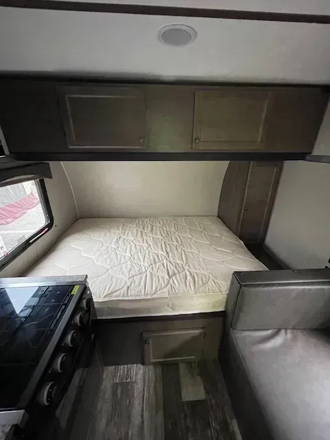 There is a bed in the back of a trailer.