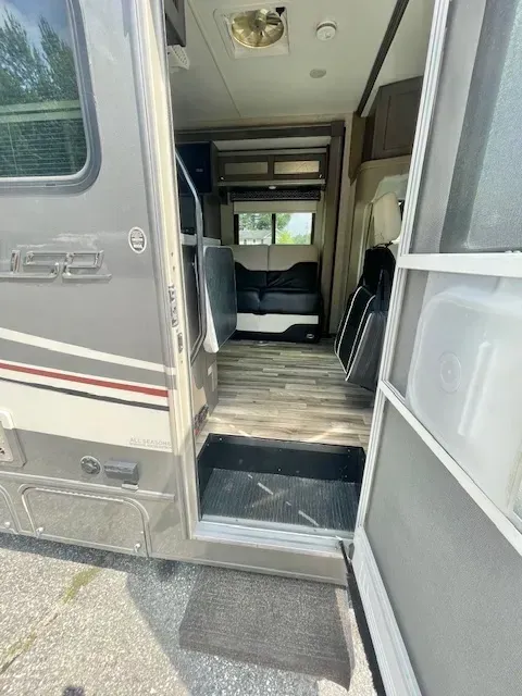 The inside of a rv with the door open.