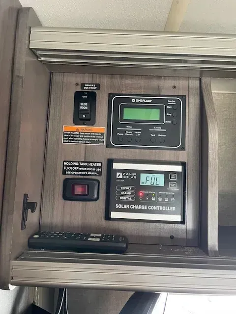 A rv with a solar charge controller and a remote control