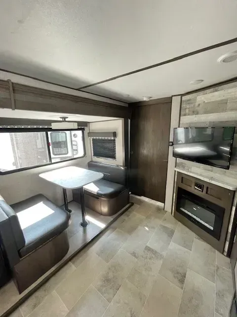 A living room with a table , couch , and television.