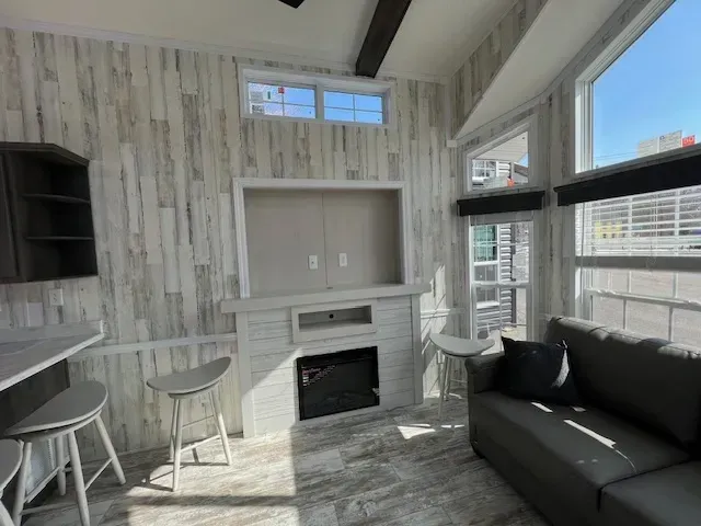 A living room with a couch , fireplace and television.