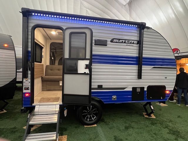 A blue and white trailer with the door open