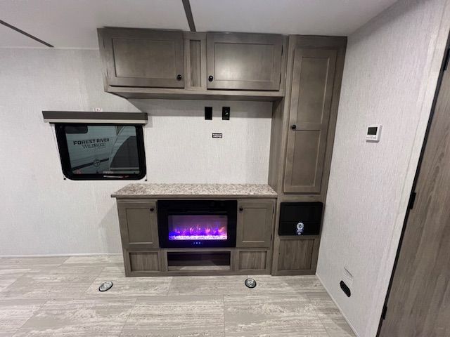There is a fireplace in the middle of the room.