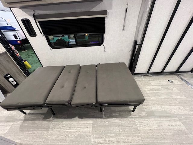 An RV with a bed in the middle of the room.