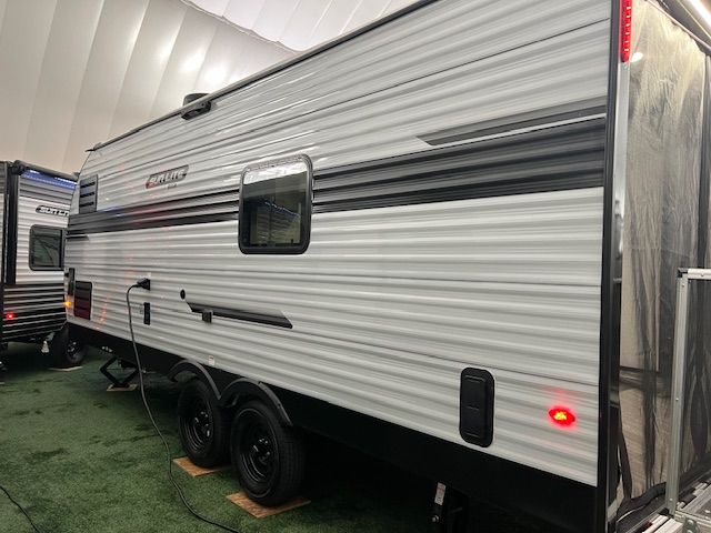 A white RV is parked in a warehouse.